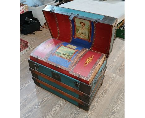 An American domed top shipping trunk, circa 1900, wood bound and metal mounted, transfer decorated interior, labelled 'From M