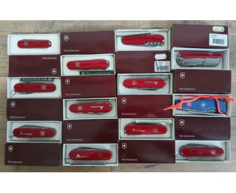 A group of twelve Victorinox Swiss Army multi-tool pen knives including Skipper, Ranger, Craftsman, Ambassador and Compact.