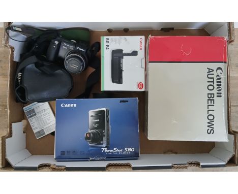 A box including two Canon digital compact cameras; Powershot Pro1 and Powershot S80, and Canon accessories.