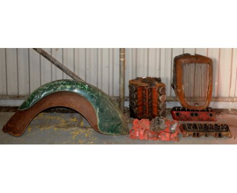 A V8 American engine, grill, two front mudguard wings and miscellaneous other vehicle parts, possibly American 