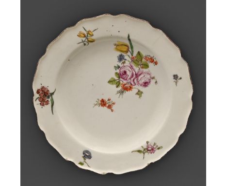 A Chelsea plate, c1755, enamelled with flower sprays in iron red rim, 23cm diam, anchor in red enamel  Provenance: Willis Col