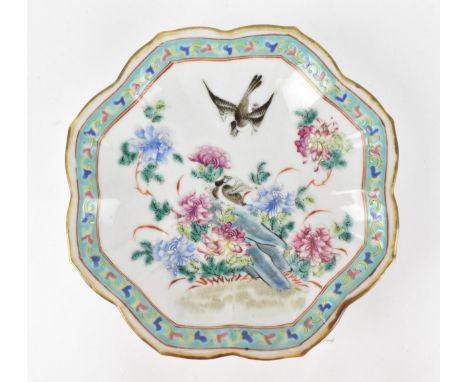 A Chinese Tongzhi porcelain pedestal dish, circa 1862-1874, with petal gilt border, the centre with pink and blue enamel peon