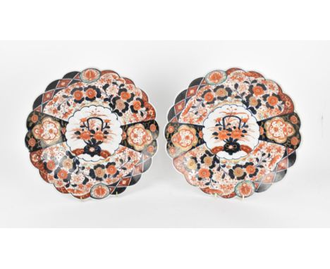 A pair of Japanese Meiji period kinrande chargers, in the imari palette, with petal rim, centered with a floral arrangement m