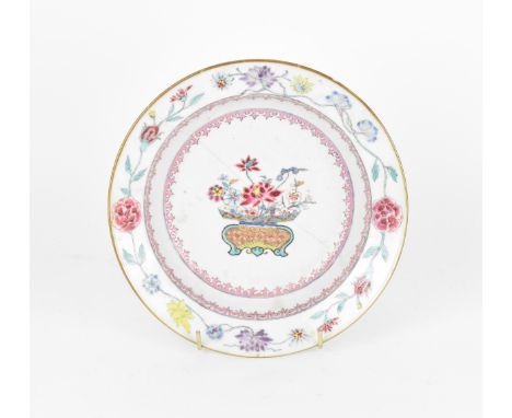 An early 18th century Chinese porcelain plate, Yongzheng period (1723-35), with polychrome enamel floral arrangement in an an