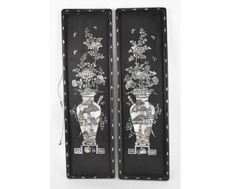 A pair of Chinese mother-of-pearl inlaid decorative panels, each depicting flowers on branches, in a precious vase on stand, 