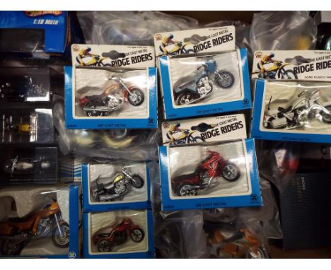 A collection of approximately 37 diecast scale model motor bikes to include Maisto, HotWheels, Ridge Riders, all mint, some b