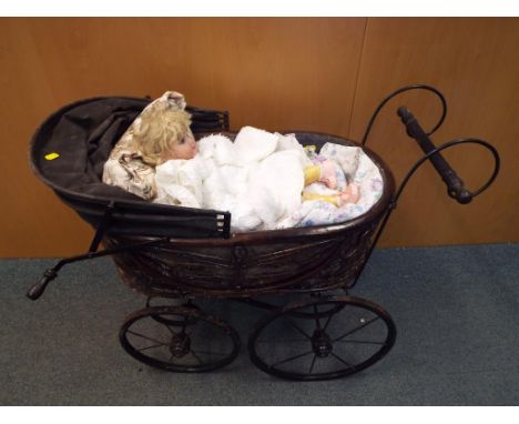 A good lot to include a vintage wicker dolls pram with metal chassis and wheels 70 cm x 87 cm x 50 cm, a vintage doll with pa