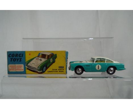 Corgi Toys - Aston Martin D.B.4 Competition Model # 309. Turquoise and white body, yellow interior, jewelled headlights, raci