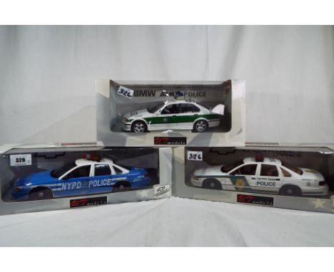 UT Models - two 1:18 scale diecast models, North American police cars, New York and Metro Dade, and a German BMW Polizei car,