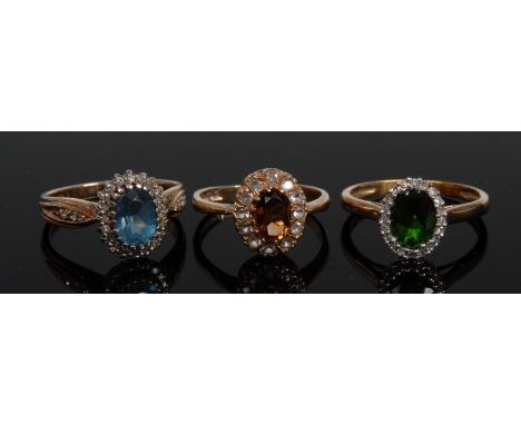 Rings - a garnet and diamond oval cluster ring;  another;  a topaz and diamond ring, all 9ct gold shanks (3) 7,8g gross
