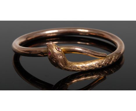 A 9ct gold hollow snake bangle, pink ruby eyes, 13g