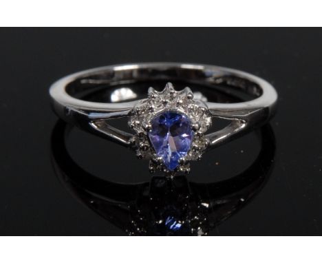 A new tanzanite and diamond ring, teardrop tanzanite, surrounded by a band of fourteen round cut diamond accents, 9ct white g