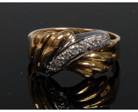 A diamond encrusted white & yellow gold ring, double fan crest, divided by a row of seven round brilliant diamond accents, 18