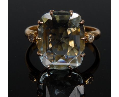 An aquamarine and diamond ring, central rounded rectangular cushion cut baguette aquamarine, approx 5.5ct, flanked to each sh