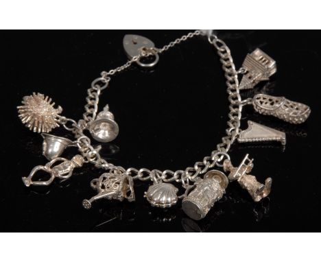 A silver charm bracelet, curb link bracelet suspending eleven charms including, Hedgehog, Chamber Stick, Harp, Stein,  Wateri