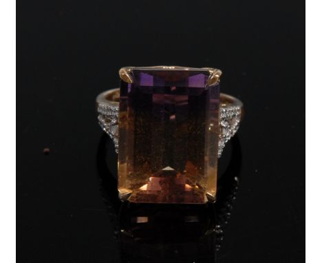 An Amentrine and diamond ring, central octagon amentrine, 13.63ct, flanked by open shoulders encrusted with thirty round and 