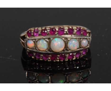 A Victorian opal and garnet cluster ring, central row of five graduating circular cabochon opals, flanked to either side by a