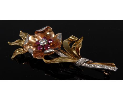 A contemporary diamond and ruby flower brooch, central round brilliant cut diamond approx 0.40ct, flanked by five smaller pin