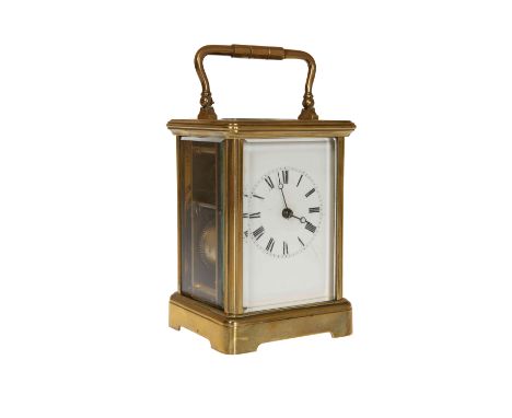 A FRENCH BRASS CASED CARRIAGE CLOCK, the white enamel dial with Roman numerals, complete with key. 13.5cm excluding handle