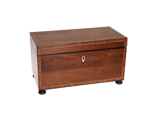 AN EARLY 19TH CENTURY MAHOGANY TEA CADDY, rectangular with twin lidded inlaid canisters and glass mixing bowl, raised on bun 
