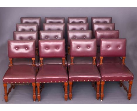 A SET OF SEVENTEEN VICTORIAN OAK AND UPHOLSTERED DINING CHAIRS, each with two-button back, raised on faceted legs continuing 