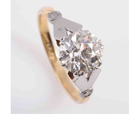 A DIAMOND RING, the brilliant cut diamond six double claw set in a pierced mount between split detail V shaped shoulders with