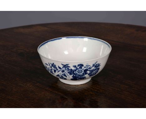 A FIRST PERIOD WORCESTER BLUE AND WHITE BOWL, painted with floral sprays, crescent mark. 16cm wide