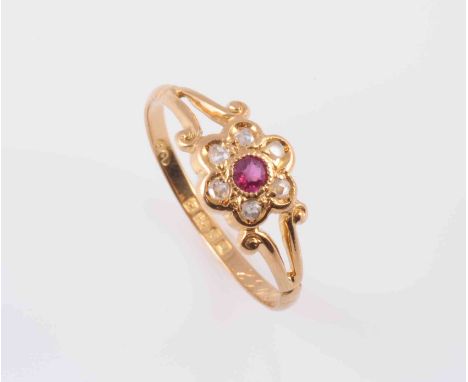 A RUBY AND DIAMOND RING, circa 1890, the flower head shaped mount set to the centre with a single round mixed cut ruby highli