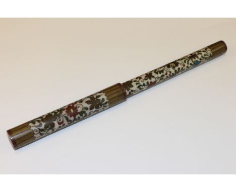 A CHINESE CLOISONNE BRUSH, PROBABLY 19TH CENTURY, cylindrical with pull-off cover, enamel decorated with scrolling flowering 