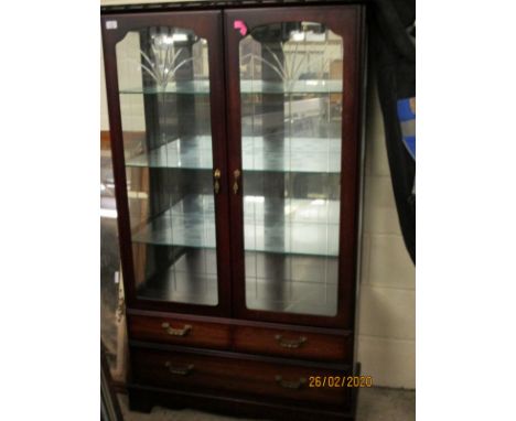 CHERRY WOOD TWO ENGRAVED DOOR DISPLAY CASE WITH TWO FULL WIDTH DRAWERS TO BASE, RAISED ON BRACKET FEET