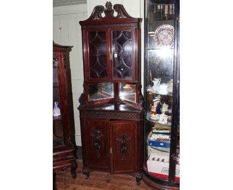 Late Victorian mahogany Chippendale style corner cupboard having two glazed panelled doors above two mirrored panels and two 