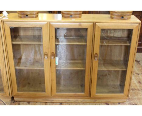 Ercol Windsor three door bookcase, 98cm by 136cm.