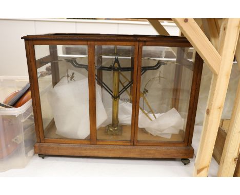 A large mahogany cased set of chemist's beam scales, 70 cms wide x 58 cms high.