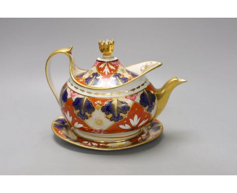 A Barr Flight and Barr Worcester teapot cover and stand painted with an Imari pattern, c.1805, 23 cm long