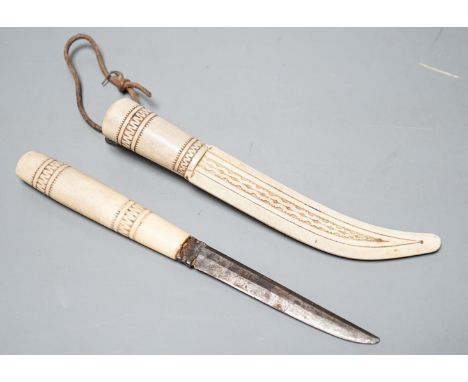 A 19th century Inuit carved stag antler dagger and scabbard, initialled ‘K.E’.