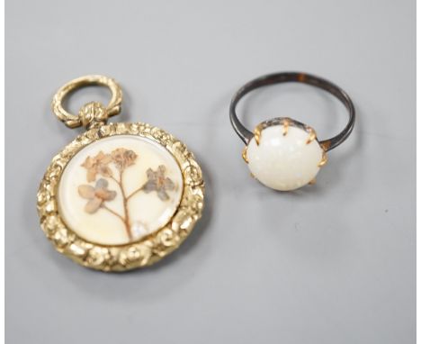 A yellow metal and white opal ring, size K/L and a late Victorian engraved yellow metal pendant, 25mm.