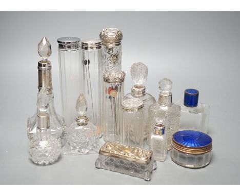 A collection of assorted mainly silver-capped scent bottles and toilet jars, etc. including two gilt metal and enamel.