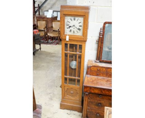 A 1930's chiming longcase clock, square silvered Roman dial in carved and panelled oak case, height 183cm