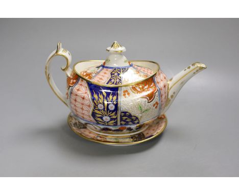 A Chamberlain teapot cover and stand painted with an Imari pattern, c.1810, 26cm long