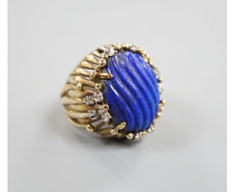 A pierced fluted 14k yellow metal, lapis lazuli and diamond set modernist dress ring, size K/L, gross weight 15.3 grams.