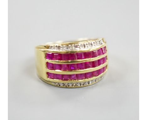 A modern 14k yellow metal, five row ruby and diamond set dress ring. size O, gross weight 4.9 grams.