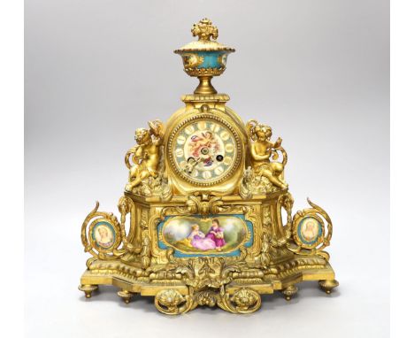 A 19th century French ormolu and Sevres style porcelain mounted mantel clock, with key and pendulum, 35 cm high