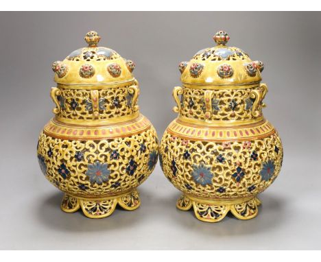 A pair of Zsolnay Pecs Persian inspired vases and covers, 27 cms high.