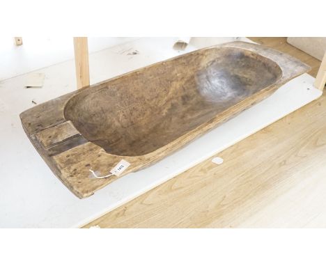 A large 19th century European fruitwood dough trough hewn from a single piece of wood. 132cm x 49cm. *This lot is being sold 