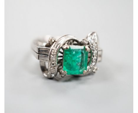 A modern 14k white metal and single stone emerald ring, with diamond chip set scroll setting, size K/L, gross weight 4.5 gram