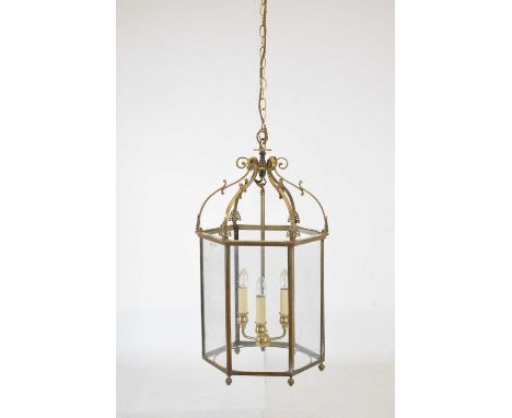 Reproduction Regency glazed brass hall lantern, the hexagonal shade with palmette finials enclosing four branch fitting, 43cm