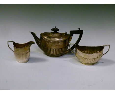 Late Victorian batchelor's silver three-piece tea set, comprising tea pot, milk jug, and sugar basin, all of part-reeded oval