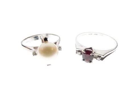 Two white gold dress rings, one set garnet-coloured stone and two diamonds, stamped '585 14K', size V approx, the other set a