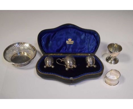 George V cased three-piece silver cruet set, Birmingham 1910, together with a pierced basket (10cm diameter), small trophy an