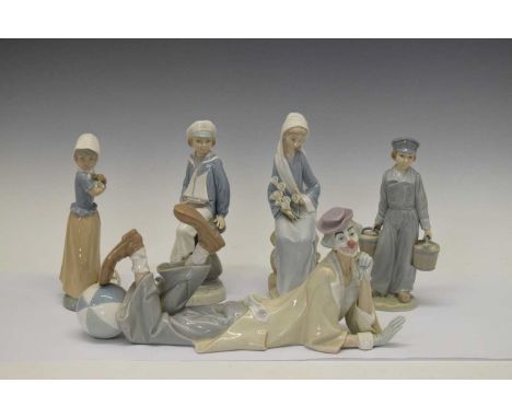 Lladro clown, together with three Lladro figures, and a Nao figure, 36cm long and smaller (5)
